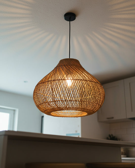 Gourd-shaped handwoven rattan pendant with black canopy, Ø40 cm (15.75”) × H33 cm (12.99”); E27 LED. Warm patterned glow casts rays on the ceiling; shown over a kitchen island, ideal for dining or breakfast bars.